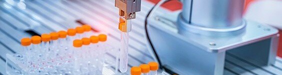 robot arm grabbing a test tube with an orange cap