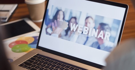 Open laptop with webinar image on the screen