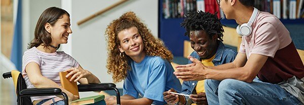 a group of students in the library chatting